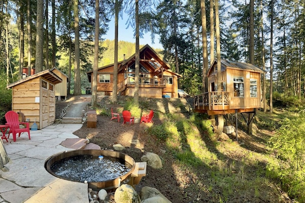 The setting of this cabin is superb, on a hillside with views on both sides. Paths wind through the backyard, to the firepit, hammock, shower house and the cedar hot tub!