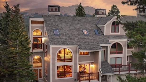 A multi-story house with a garage, large windows, and a balcony. - Amazing Views | Walk or Free Shuttle to Town (Breckenridge)