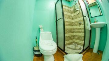 Un baño con inodoro, ducha y lavabo.