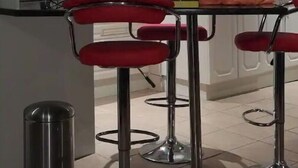 A kitchen with white cabinets, a microwave, a blender, and a red bar stool. - A home away from home (Mbombela)