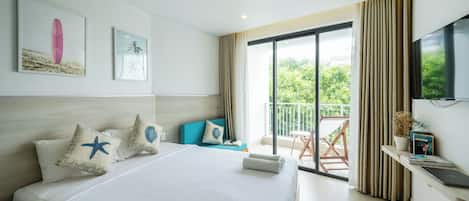 Una habitación de hotel con una cama grande, un balcón con vistas y un televisor en la pared.