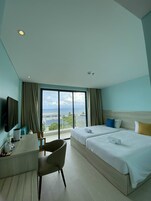Deluxe Twin Room, Balcony, Sea View | Minibar, individually decorated, individually furnished, desk