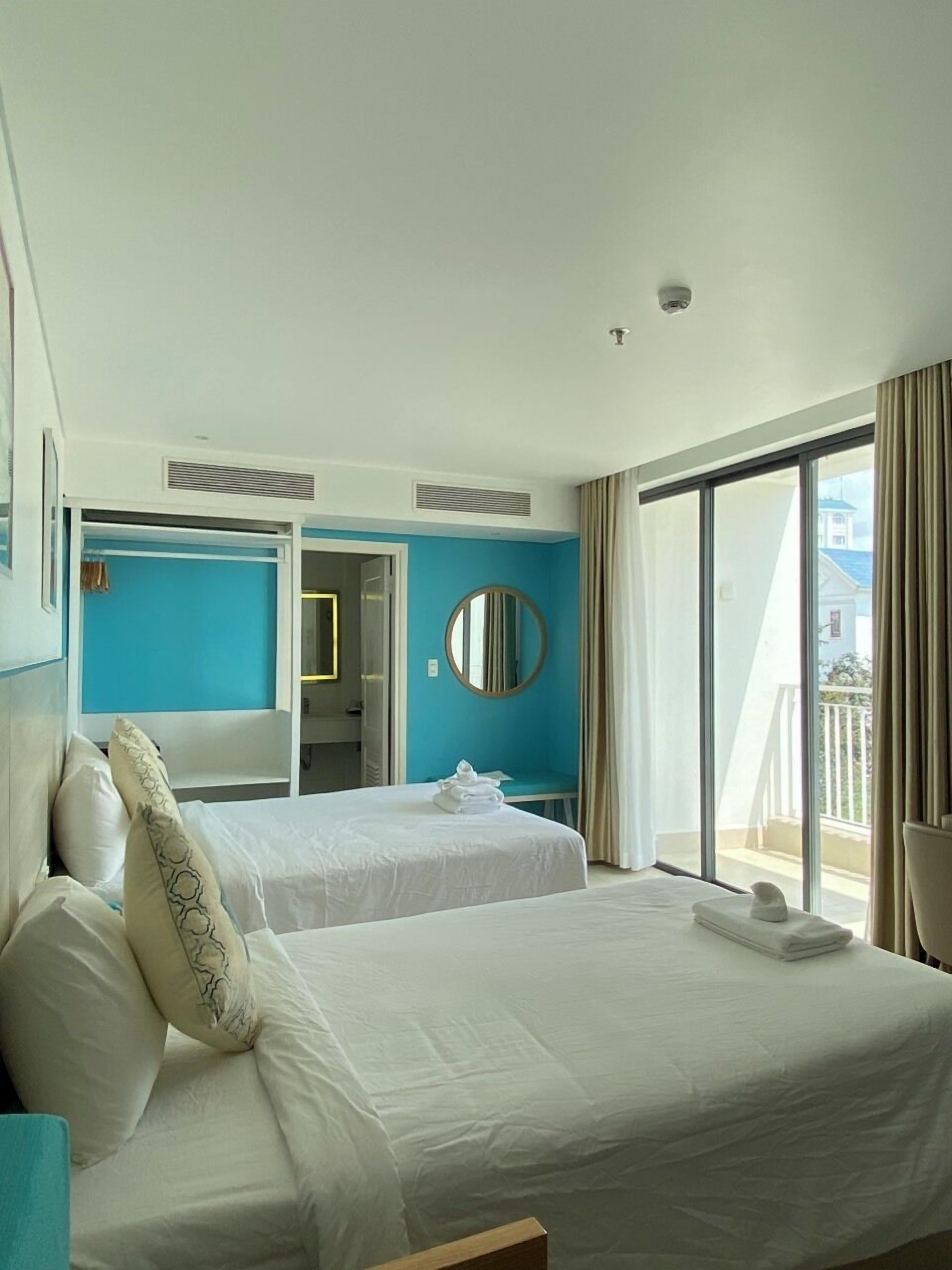 Room, Multiple Beds, Partial Sea View | Minibar, individually decorated, individually furnished, desk
