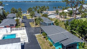 A coastal residential area with houses, a swimming pool, and a view of the ocean.