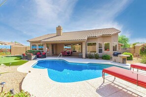 A residential property with a swimming pool, patio furniture, and a covered outdoor area. - Tatum Ranch Retreat | Heated Pool & Backyard Fun (Cave Creek)