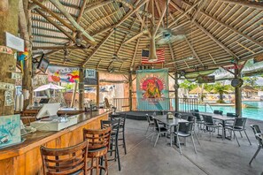 Relax by the pool at the Purple Parrot Bar, where you can enjoy a refreshing drink at the bar.