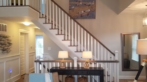 A staircase with white railings and a wooden handrail, leading to an upper floor. - 159 26th Street - Spacious home in the heart of Avalon, two blocks to beach. (Avalon)