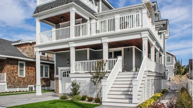 A two-story house with a balcony and a covered porch. - 159 26th Street - Spacious home in the heart of Avalon, two blocks to beach. (Avalon)