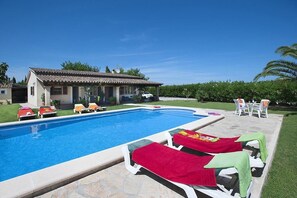 A swimming pool with lounge chairs and a house in the background. - Finca Burga, vacation home in a quiet location, views, pool, A/C, Wifi (Puerto Pollenca)