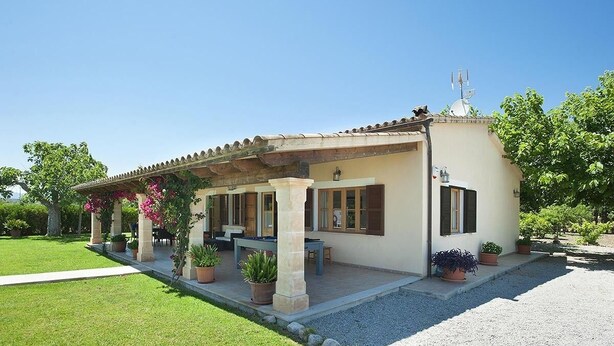 A house with a covered patio, outdoor seating, and potted plants. - Finca Burga, vacation home in a quiet location, views, pool, A/C, Wifi (Puerto Pollenca)