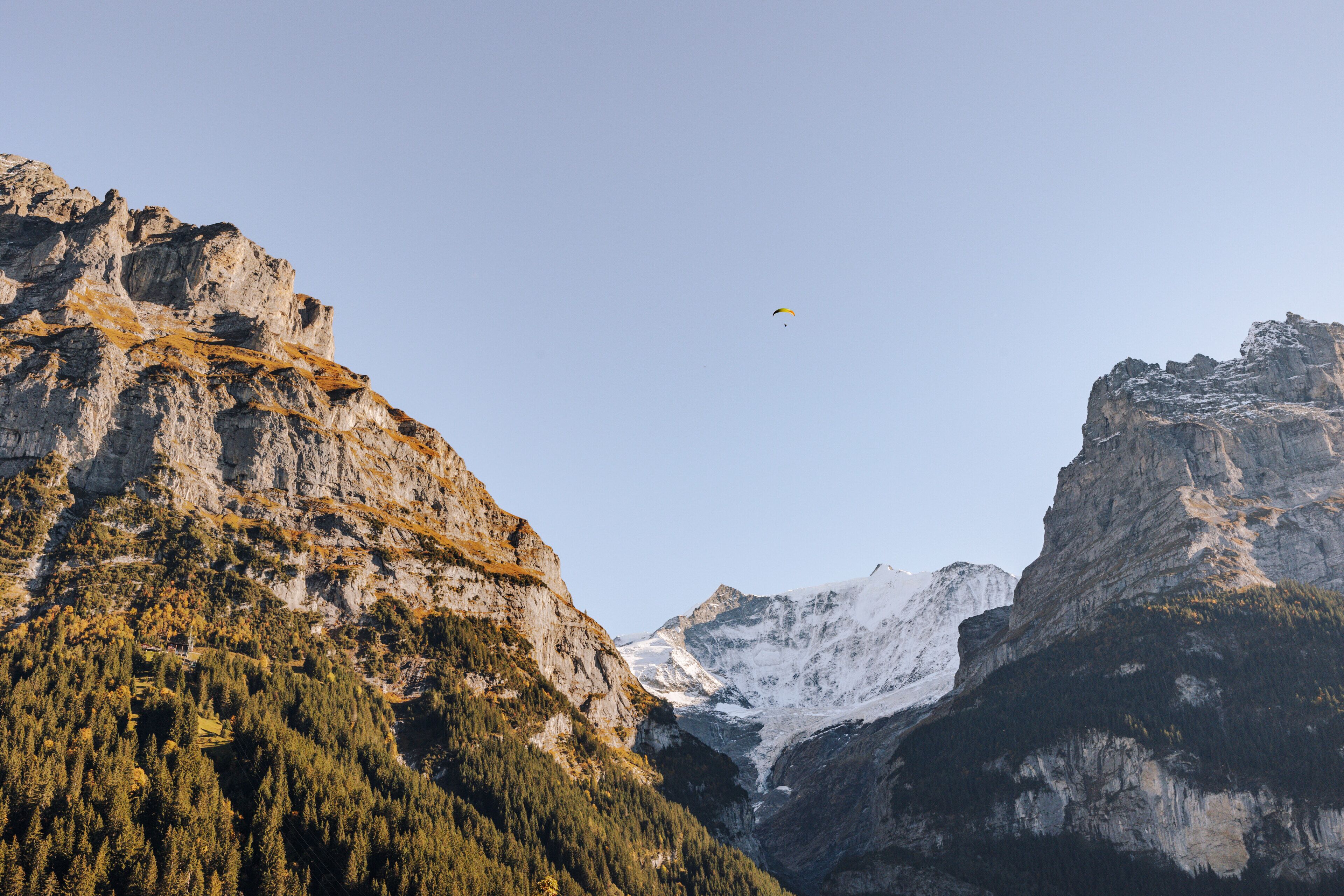 A mountainous landscape with rocky cliffs and a valley.