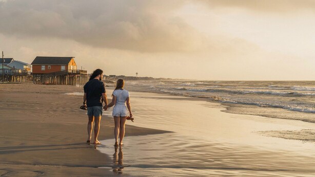 A beach with a pier and houses in the background. - Steps to Surfside Beach | Games, Views & Pets (Surfside Beach)