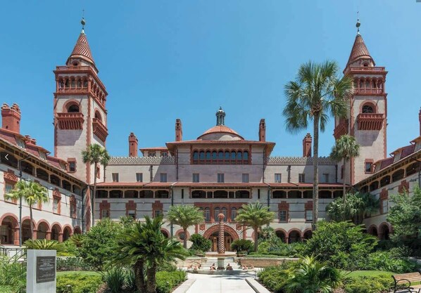 A large building with two towers, a central dome, and a courtyard with palm trees. - One-of-a-Kind Home | Firepit & Terrace, Walk Beach (St. Augustine)