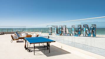 Relax and socialize on the outdoor terrace with a ping pong table and comfortable seating.