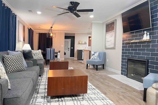 Living room area with functional electric fireplace and television