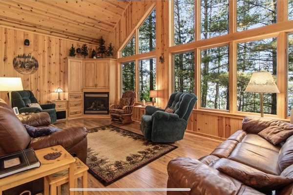 Main level living area with fireplace and TV