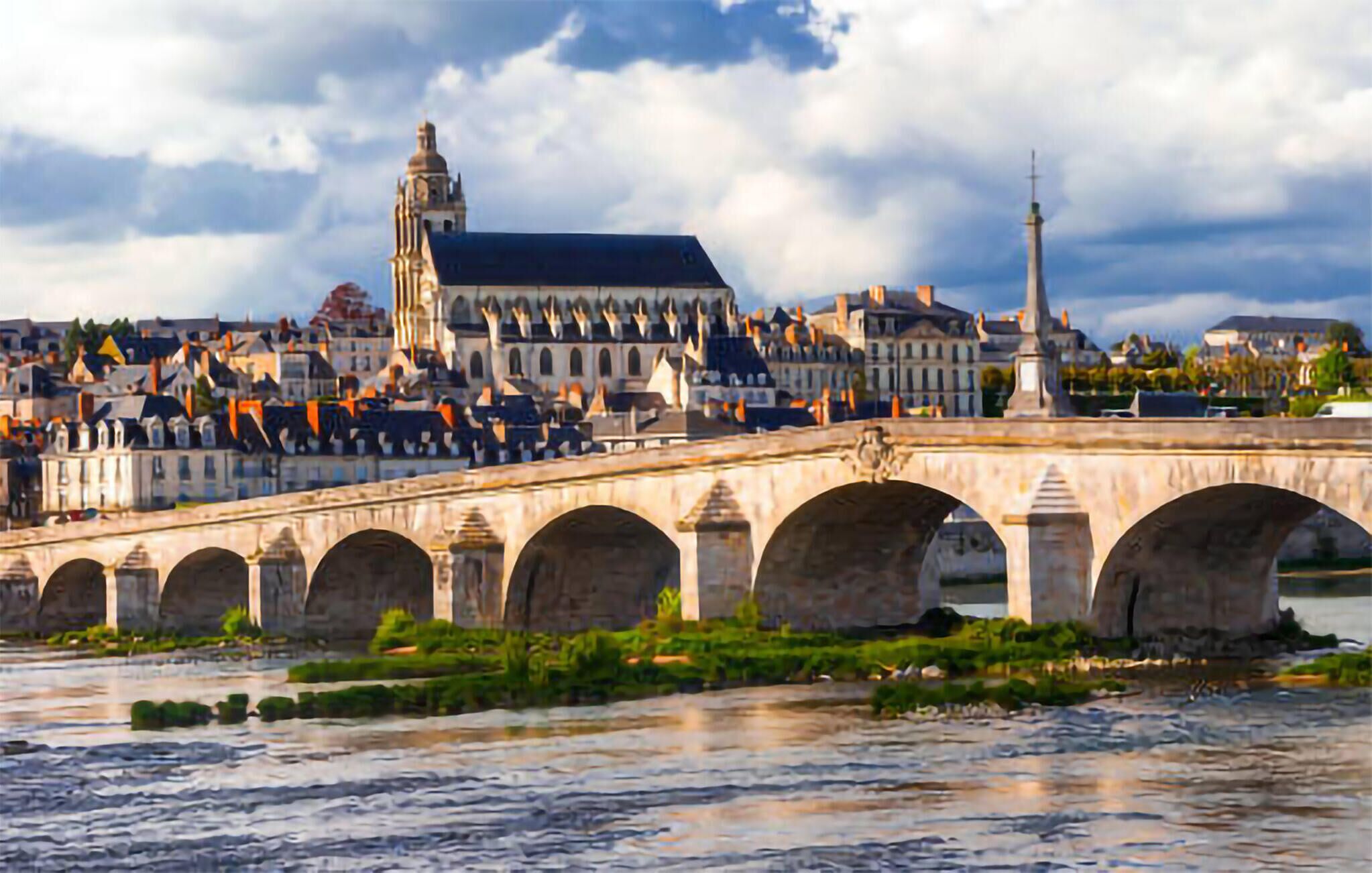 Un pont de pierre à arches multiples enjambant une rivière, menant à un paysage urbain historique caractérisé par une architecture particulière et une tour imposante.