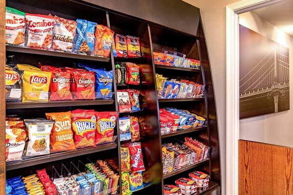 A snack aisle with various brands and types of chips and snacks.