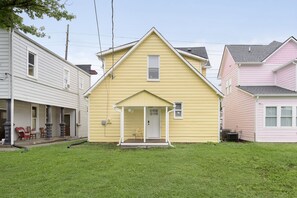 Stunning single-family home with a charming front porch and beautifully manicured lawn.