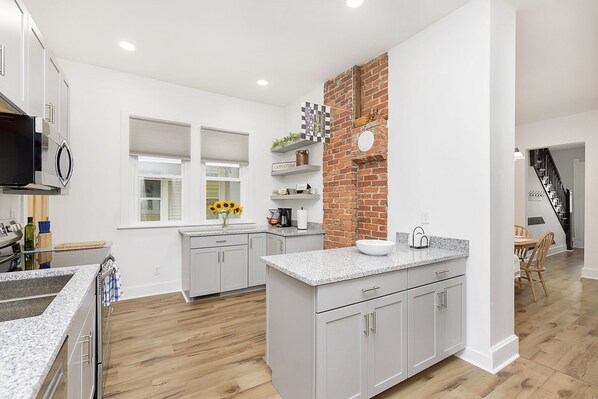 Enjoy cooking in this well-lit kitchen with an island and ample workspace.