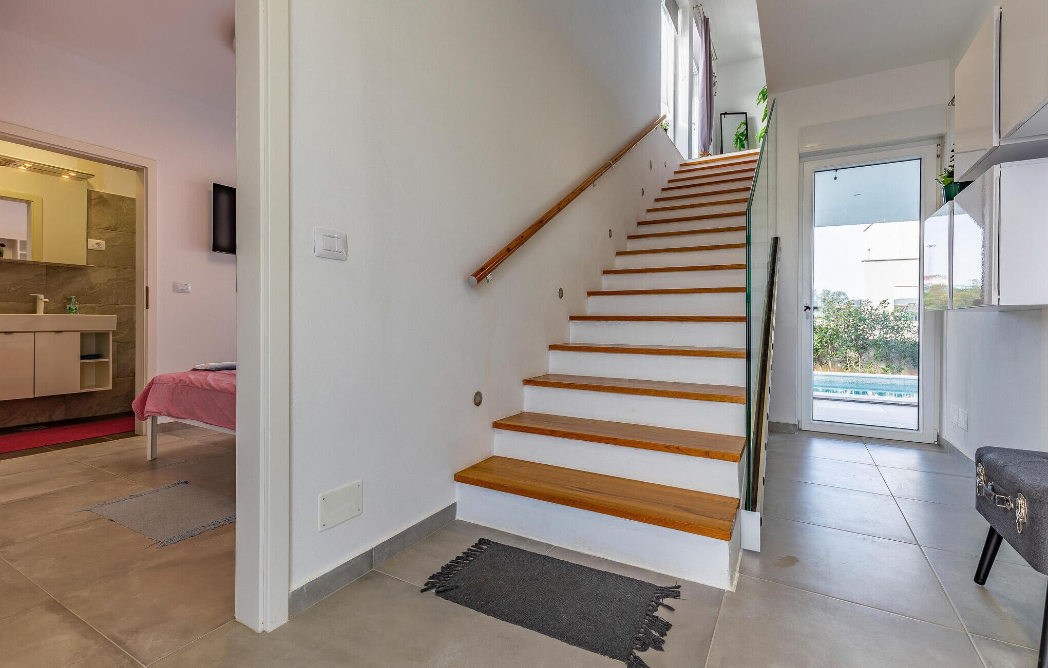 A staircase with wooden steps leading to a landing.