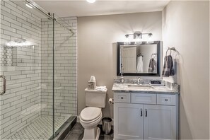 Bathtub, hair dryer, towels, toilet paper