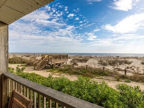 Enjoy the ocean views from the deck, surrounded by lush greenery and a low wall.