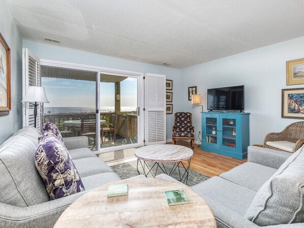 Relax in a cozy seating area with a sofa, armchair, and coffee table, perfect for unwinding or socializing.