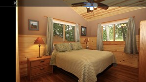 A bedroom with a bed, two nightstands, a ceiling fan, and windows with curtains. - Cabin with amazing views, prime location and privacy! 3 bedrooms 2 bathrooms (Battle Lake)