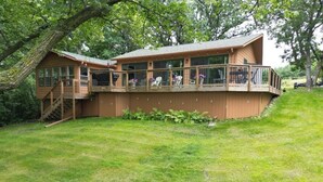 A wooden cabin with a balcony and a staircase leading to the entrance. - Cabin with amazing views, prime location and privacy! 3 bedrooms 2 bathrooms (Battle Lake)