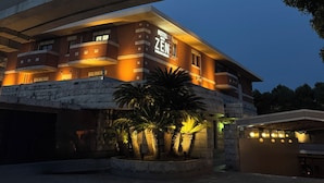 A hotel with a prominent 'HOTEL WITH ZEN' sign, featuring a modern architectural design with a stone facade and illuminated signage. - HOTEL ZEN Yokohama Hazawa (Yokohama)