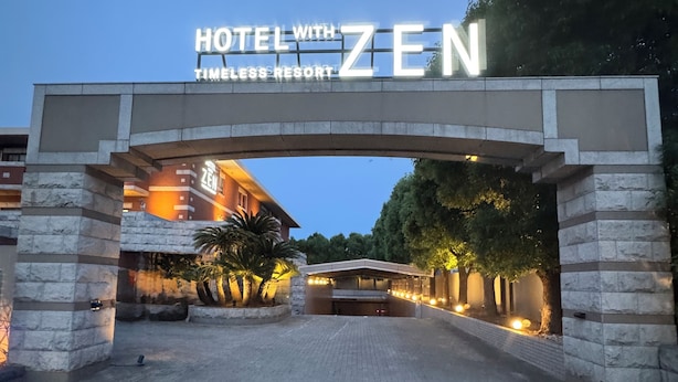 The entrance to Hotel with Zen Timeless Resort, featuring a stone archway and illuminated signage. - HOTEL ZEN Yokohama Hazawa (Yokohama)
