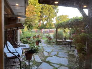 A patio area with a stone-tiled floor, potted plants, and outdoor furniture. - 5 minutes Walking to Brown,RISD, downtown, East Side (Providence)