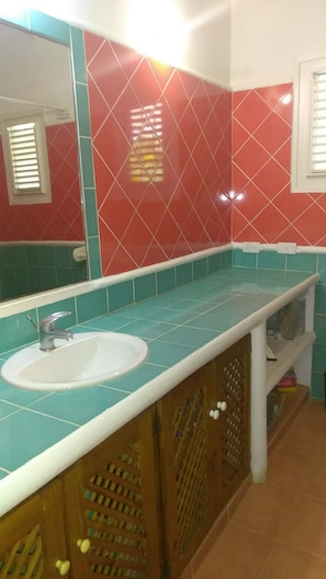 A bathroom with a white sink, a mirror, and red and teal tiled walls. - Charming Caribbean Style Villa Near Superb Beach (Las Terrenas)