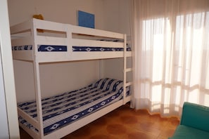 Cozy retreat with a bunk bed and a comfortable chair, perfect for a relaxing stay.