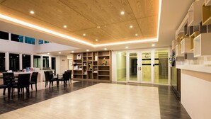 A spacious hotel lobby with a modern design, featuring a wooden ceiling, a reception desk, and a seating area with chairs. - Kata Beach Ozone Superb Fully Equipped Studio Kitchen Washing Machine Aircon (Karon)
