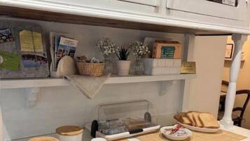 A breakfast setup with a tray, cups, and a sign indicating a 'breakfast station.'