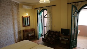 A room with a bed, a chair, a television, and a window with curtains. - The Harmony - Beachfront sea View Apartment (Corfu)