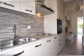 Villa, 3 Bedrooms, Patio | Private kitchen - Cosy two - Storey Villa With a Garden and a Shared Swimming Pool (Caorle)