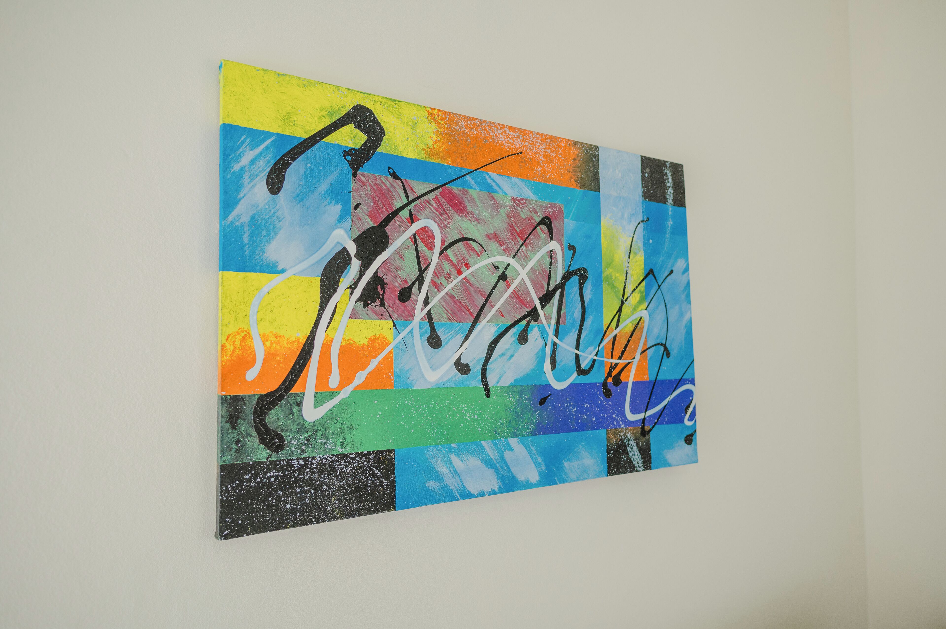 A colorful abstract painting on a wall.