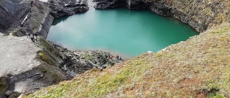 A natural pool surrounded by rocky terrain.