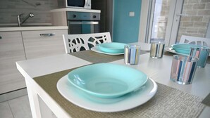 A modern kitchen with white cabinets, a microwave, and a sink. - Villa Noire 'just 900mt From The Crystalline Waters Of Salento (Nardò)