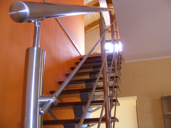 A staircase with metal railings and wooden steps.