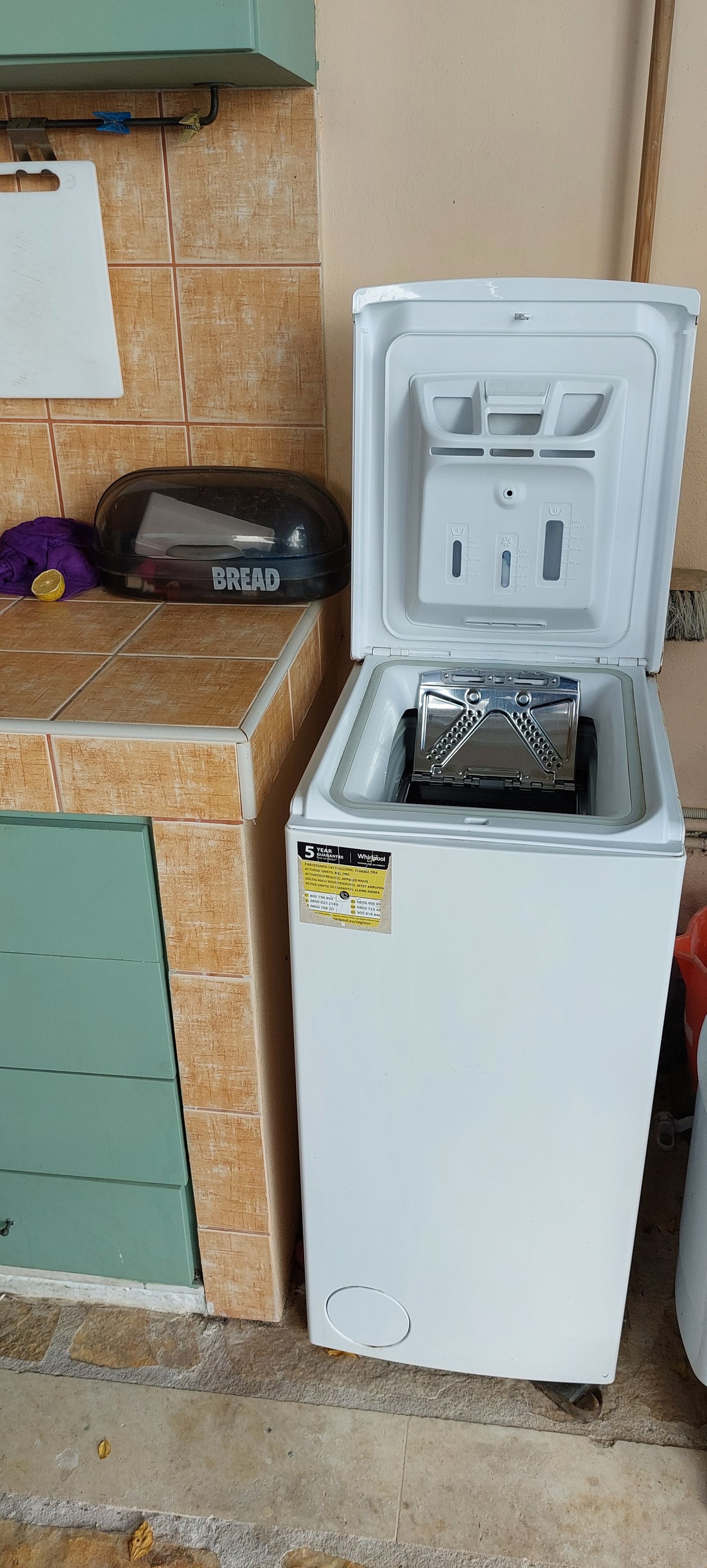 A compact refrigerator with a freezer compartment, a small built-in ice maker, and a water dispenser.