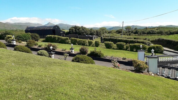 A well-maintained garden with manicured lawns, hedges, and decorative lamp posts. - Room in Apartment - 1 Bedroom In A Homely Home With A Lovely Farm (Sneem)