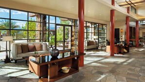 A spacious living area with large windows, a sofa, a coffee table, and a stone-tiled floor. - Westin Desert Willow Villas, Palm Desert (Palm Desert)