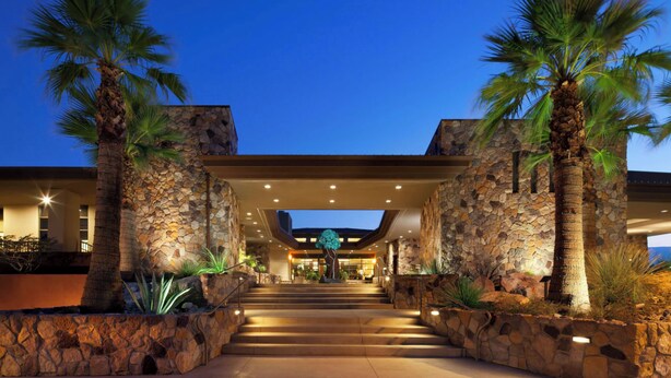 A hotel entrance with stone walls, palm trees, and a staircase leading to the lobby. - Westin Desert Willow Villas, Palm Desert (Palm Desert)