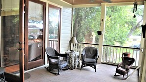 A covered porch with wicker chairs, a small table, and a lamp. - 3 Bdrm in Georgetown's Historic District (Georgetown)