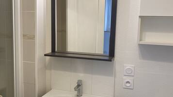 Shower, hair dryer, soap, toilet paper