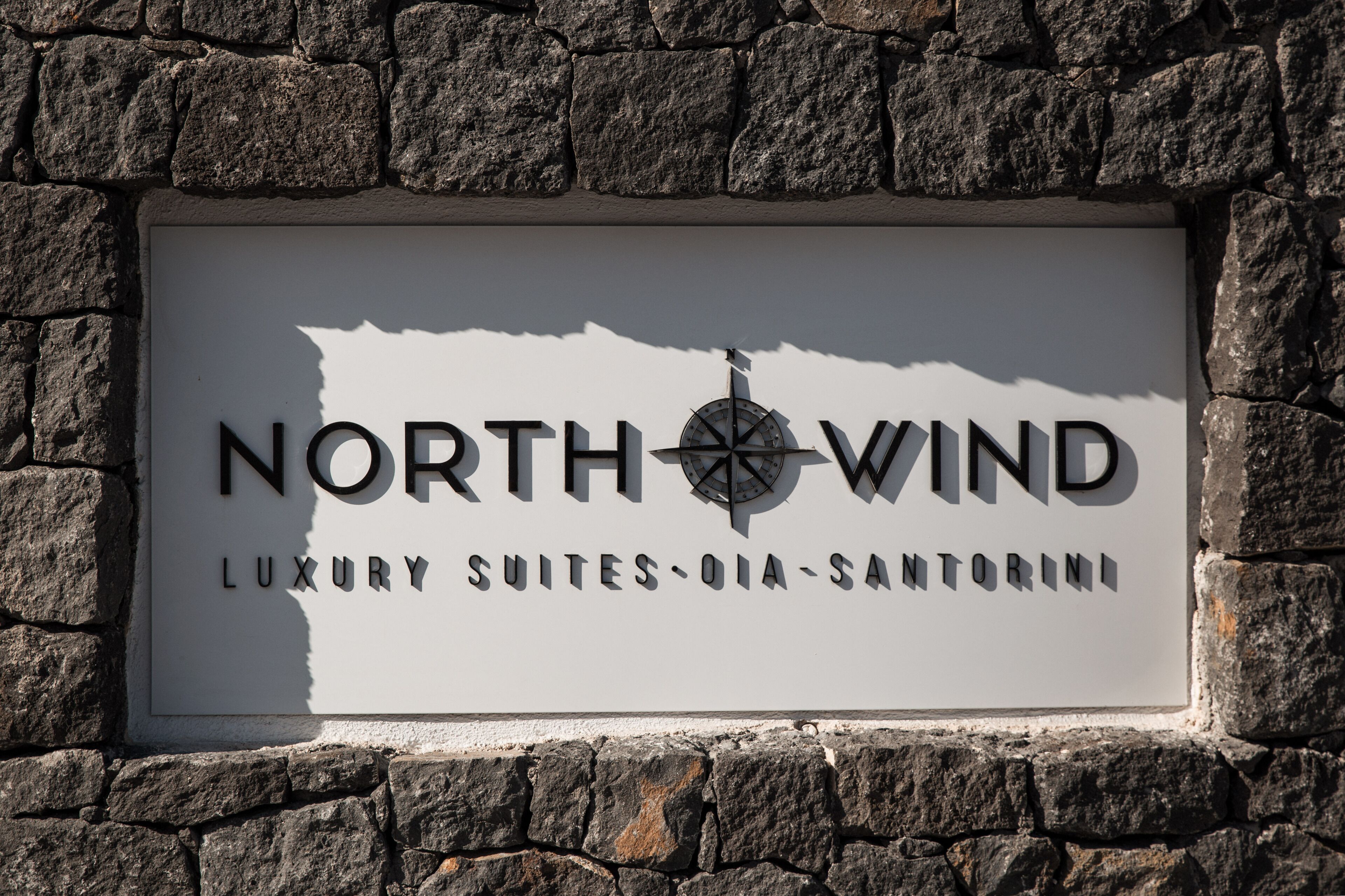 A sign for North Wind Luxury Suites, indicating a high-end accommodation option.
